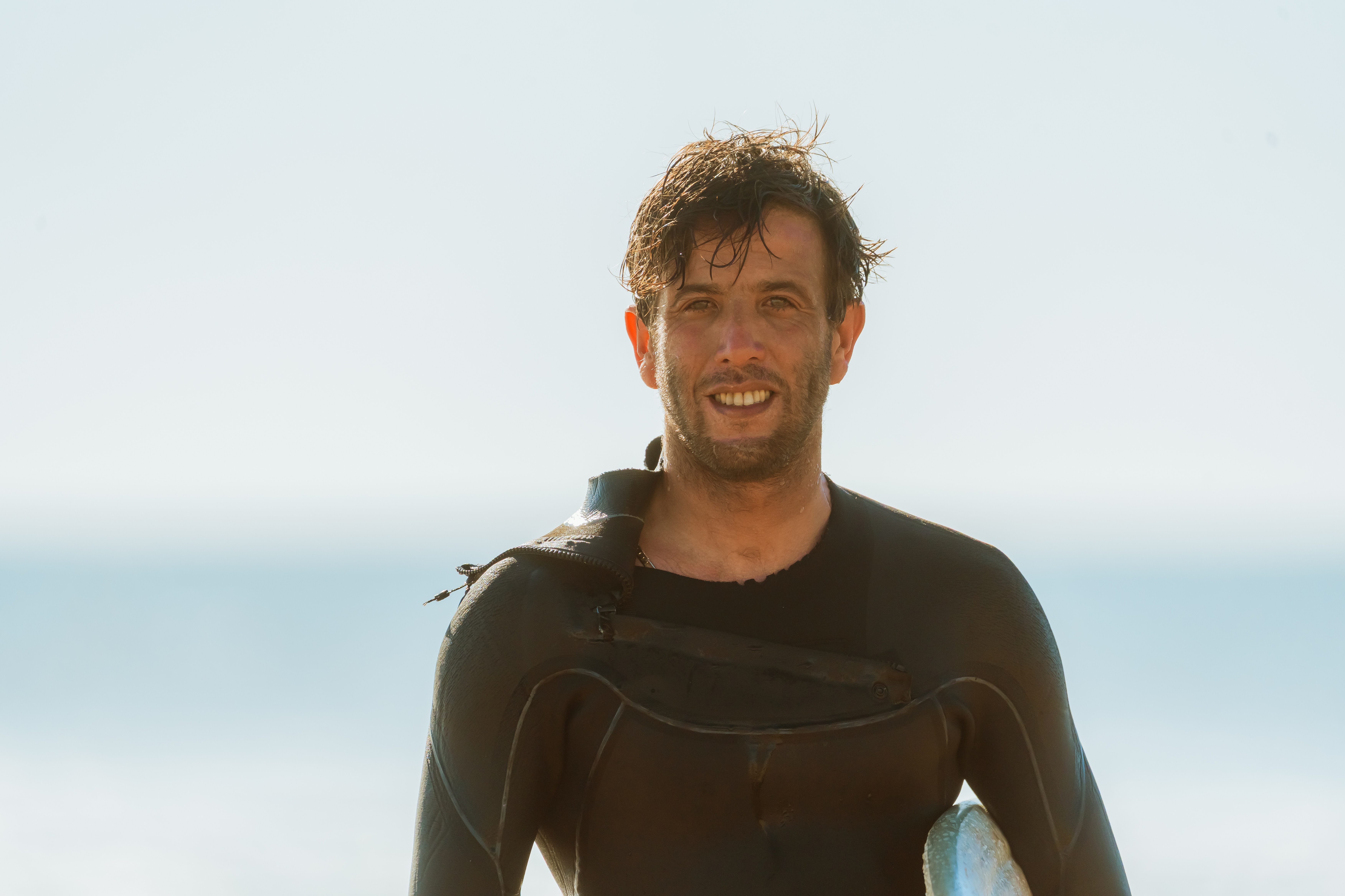 IKO certified kitesurf instructor teaching a student on the flat turquoise waters of Dakhla's lagoon at golden hour