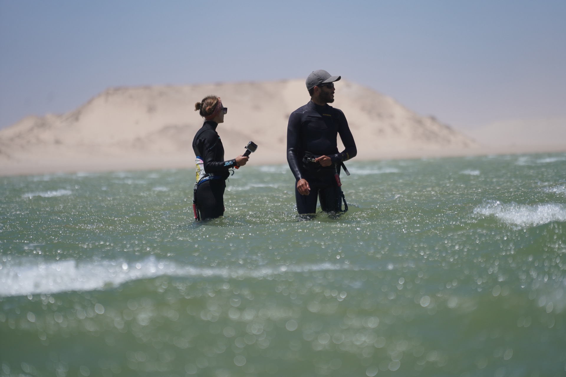 Instructor and student in the lagoon water with iconic white dune in background